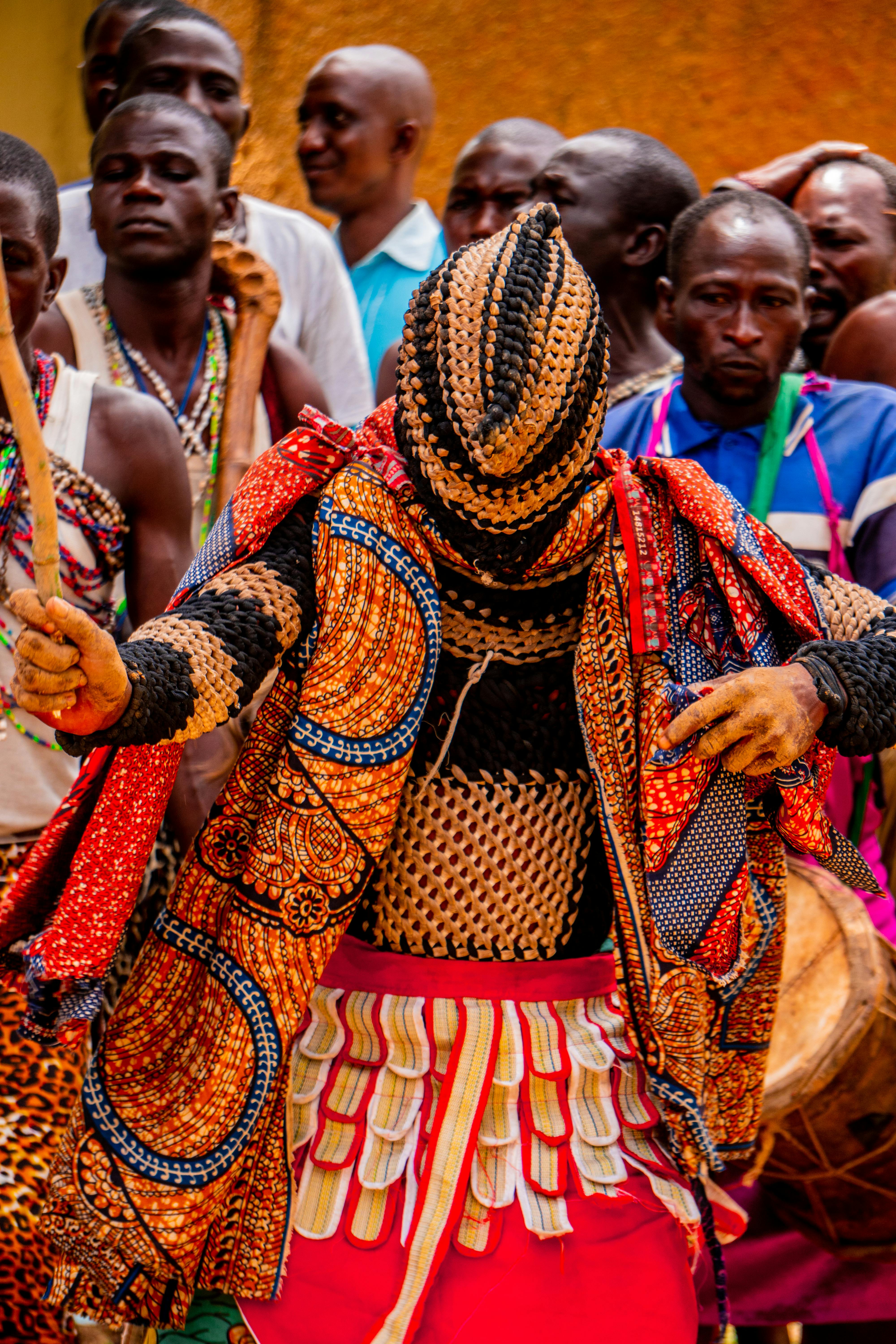 Colorful traditional tribal dancers performing at a vibrant festival, showcasing cultural heritage.